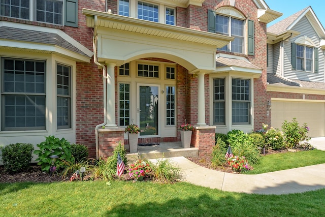 7294 Mackenzie Ln, Portage, MI 49024 - entrance to property featuring brick siding, a garage, and driveway