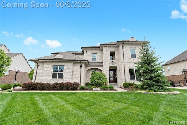 10611 Stoney Point Dr, South Lyon, MI 48178 - view of front of house with a front yard and brick siding
