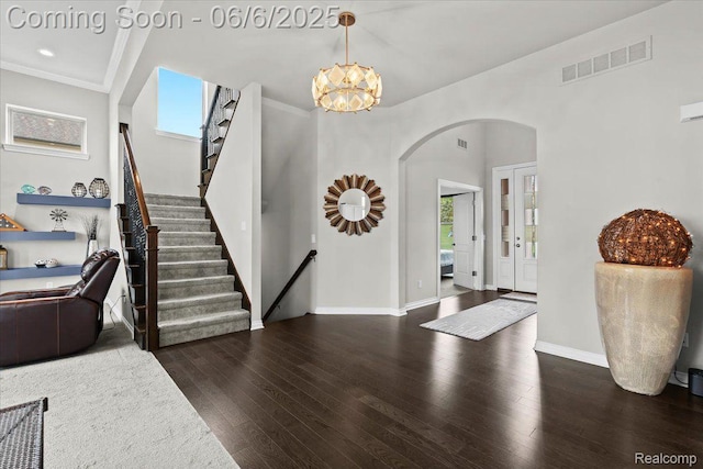 10611 Stoney Point Dr, South Lyon, MI 48178 - entryway featuring arched walkways, wood finished floors, stairs, crown molding, and baseboards