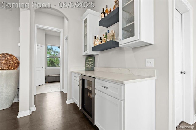 10611 Stoney Point Dr, South Lyon, MI 48178 - indoor dry bar featuring beverage cooler, baseboards, and dark wood-style floors