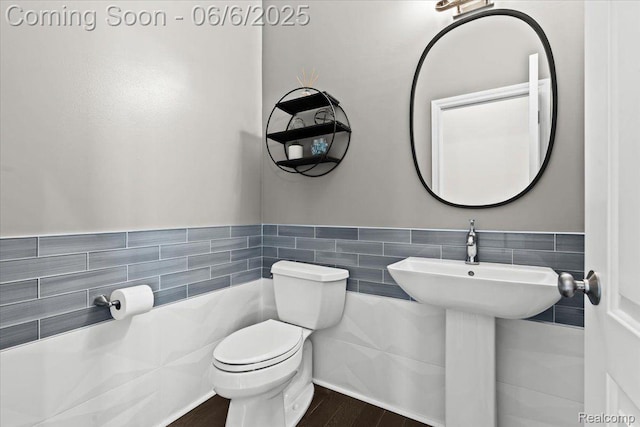 10611 Stoney Point Dr, South Lyon, MI 48178 - half bath with tile walls, toilet, wood finished floors, and wainscoting