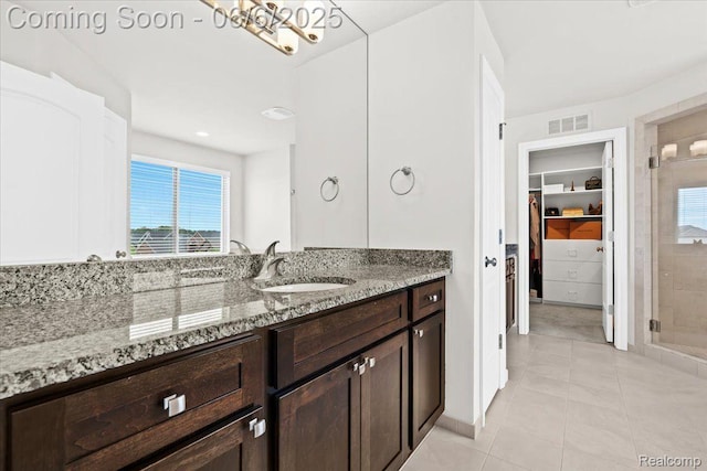 10611 Stoney Point Dr, South Lyon, MI 48178 - bathroom with healthy amount of natural light, a shower stall, tile patterned floors, and vanity