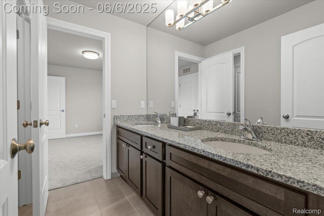 10611 Stoney Point Dr, South Lyon, MI 48178 - bathroom featuring double vanity, tile patterned flooring, and baseboards