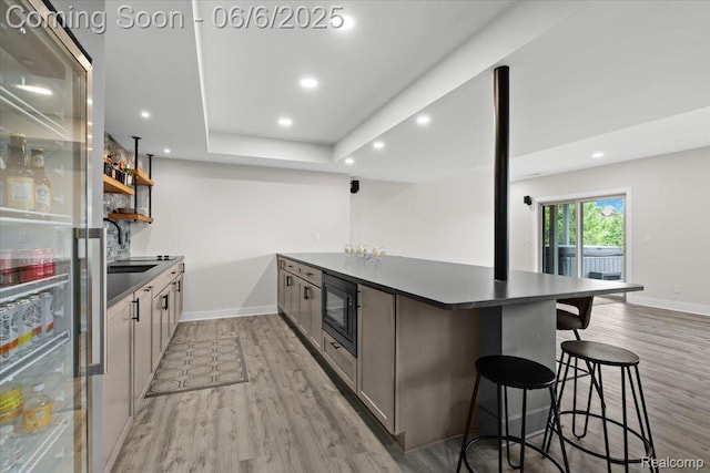 10611 Stoney Point Dr, South Lyon, MI 48178 - kitchen with dark countertops, black microwave, light wood-style floors, baseboards, and recessed lighting