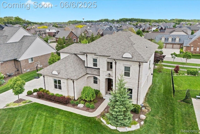 10611 Stoney Point Dr, South Lyon, MI 48178 - french provincial home with a residential view, brick siding, and roof with shingles