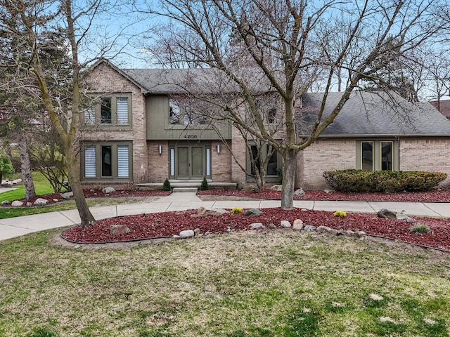 4206 Southmoor Ln, West Bloomfield, MI 48323 - view of front facade featuring a front lawn, brick siding, and roof with shingles