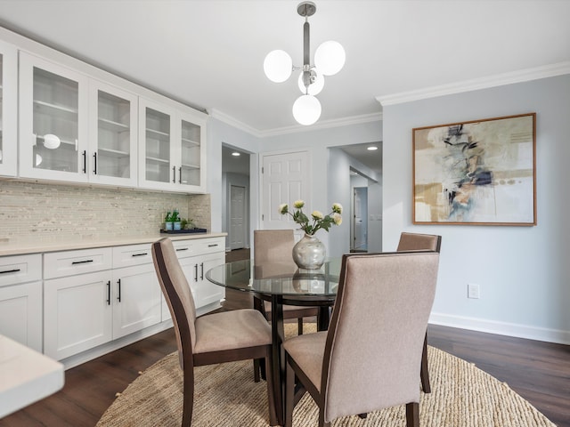 4206 Southmoor Ln, West Bloomfield, MI 48323 - dining area featuring dark wood-style flooring, ornamental molding, baseboards, and a chandelier
