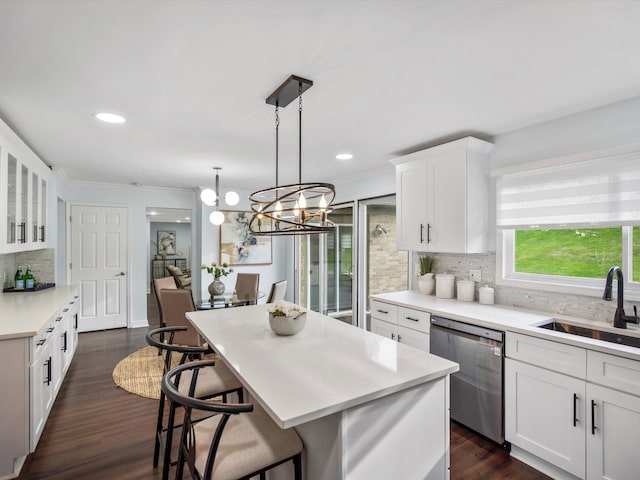 4206 Southmoor Ln, West Bloomfield, MI 48323 - kitchen featuring a sink, stainless steel dishwasher, decorative backsplash, white cabinetry, and a kitchen bar