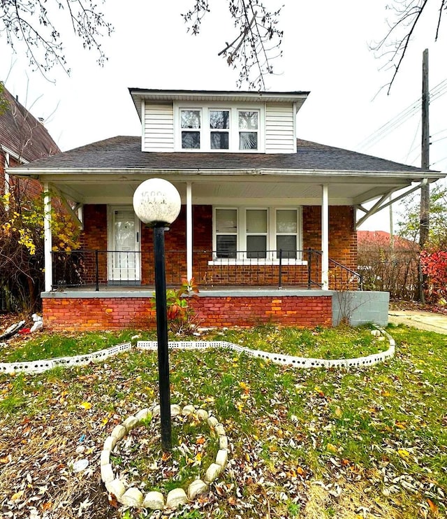 bungalow-style home with brick siding and a porch