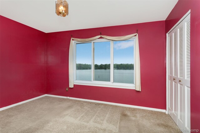 2982 Shawnee Ln, Waterford, MI 48329 - carpeted spare room with baseboards and a water view