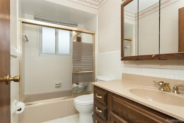 2982 Shawnee Ln, Waterford, MI 48329 - full bathroom with vanity, tile walls, toilet, bathing tub / shower combination, and a wainscoted wall