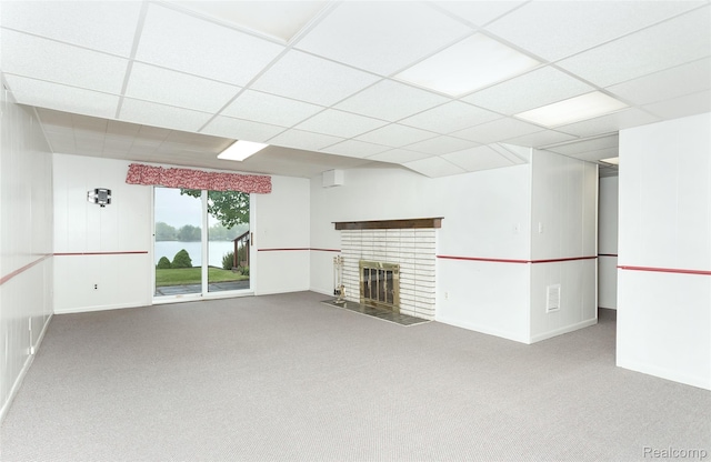2982 Shawnee Ln, Waterford, MI 48329 - unfurnished living room with carpet floors, baseboards, a fireplace, a paneled ceiling, and a water view