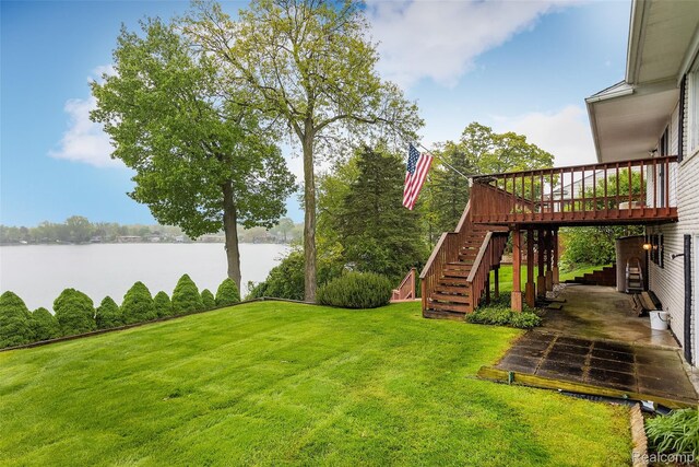 2982 Shawnee Ln, Waterford, MI 48329 - view of grassy yard with stairs and a deck with water view