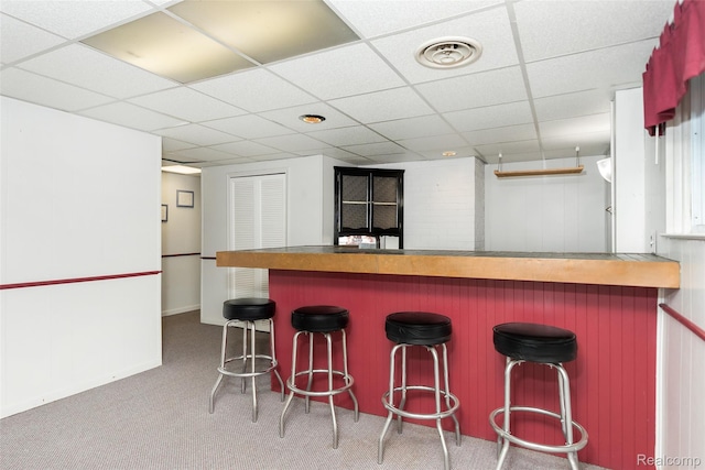2982 Shawnee Ln, Waterford, MI 48329 - kitchen with a drop ceiling, carpet floors, and a kitchen breakfast bar