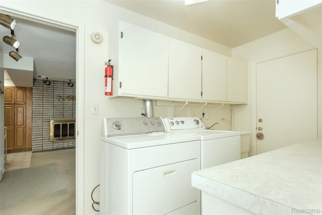 2982 Shawnee Ln, Waterford, MI 48329 - laundry area featuring cabinet space, washer and clothes dryer, a brick fireplace, and light colored carpet