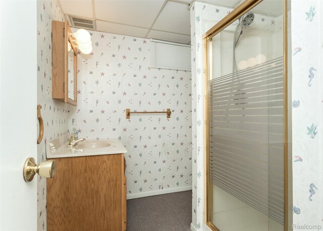 2982 Shawnee Ln, Waterford, MI 48329 - full bathroom featuring wallpapered walls, vanity, a stall shower, a paneled ceiling, and baseboards