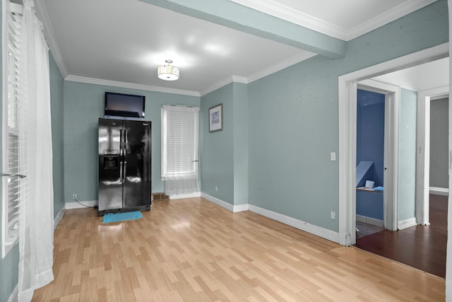 unfurnished room featuring wood finished floors, baseboards, and ornamental molding