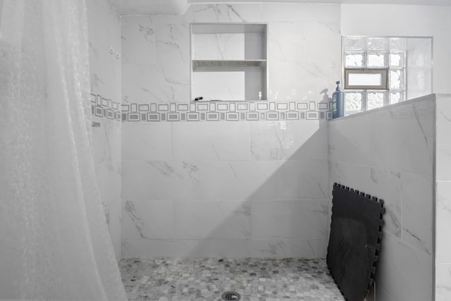 bathroom with tiled shower
