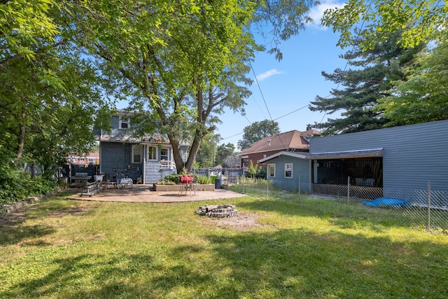 view of yard featuring a fire pit and a patio area