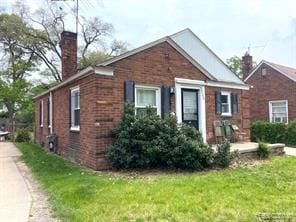 20200 Roselawn St, Detroit, MI 48221 - bungalow-style home with a chimney, brick siding, and a front lawn
