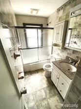 20200 Roselawn St, Detroit, MI 48221 - full bathroom with bath / shower combo with glass door, toilet, and vanity