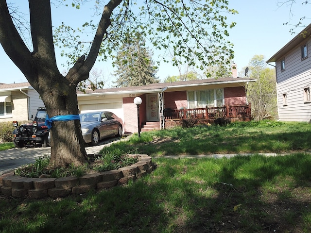 1510 S Franklin Ave, Flint, MI 48503 - single story home featuring an attached garage, brick siding, a chimney, covered porch, and driveway