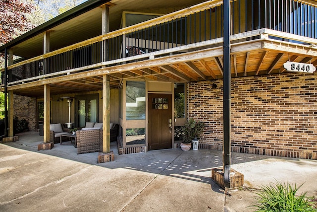 8440 Lance, Brighton, MI 48116 - property entrance with a patio area, brick siding, and outdoor lounge area