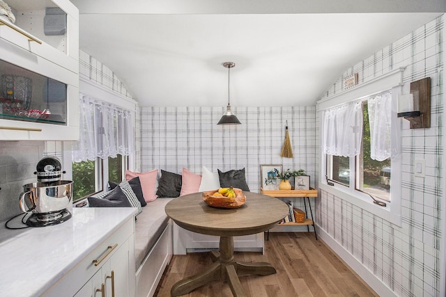 8440 Lance, Brighton, MI 48116 - kitchen with breakfast area, wallpapered walls, vaulted ceiling, light wood-style floors, and white cabinets