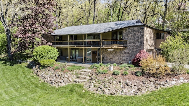 8440 Lance, Brighton, MI 48116 - back of property with brick siding, a patio area, a lawn, a wooden deck, and french doors