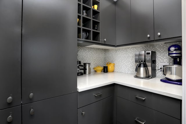 15 E Kirby St Unit 822, Detroit, MI 48202 - kitchen with gray cabinetry, decorative backsplash, open shelves, light countertops, and refrigerator