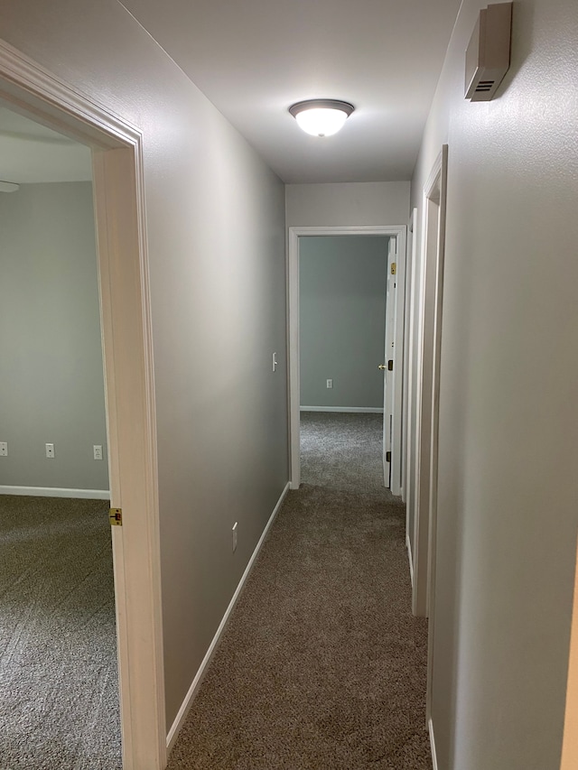 corridor featuring carpet and baseboards