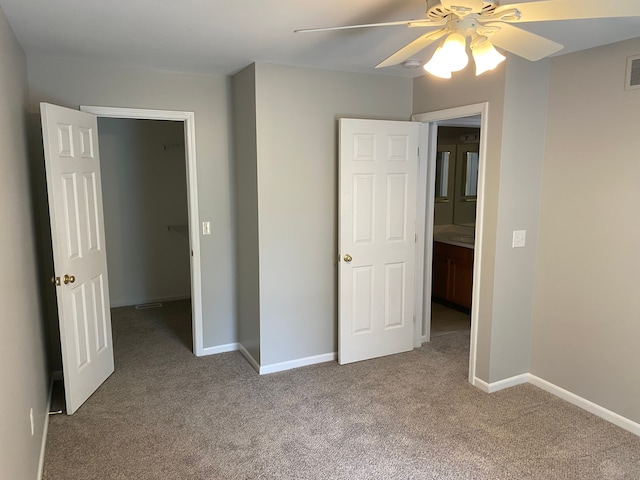 unfurnished bedroom featuring carpet flooring, baseboards, and ceiling fan