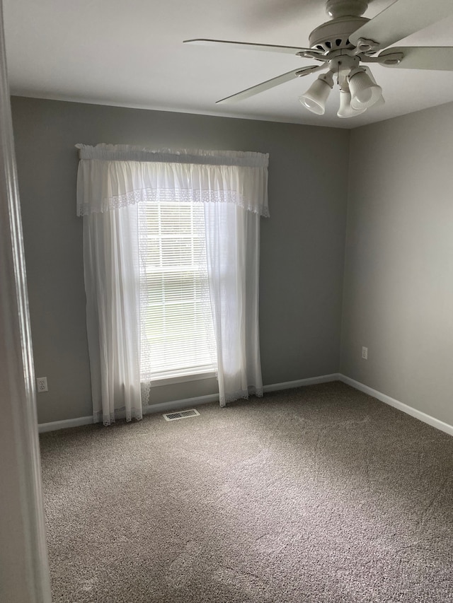 unfurnished room with ceiling fan, carpet floors, and baseboards