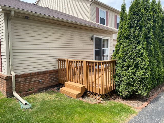 wooden terrace featuring a lawn