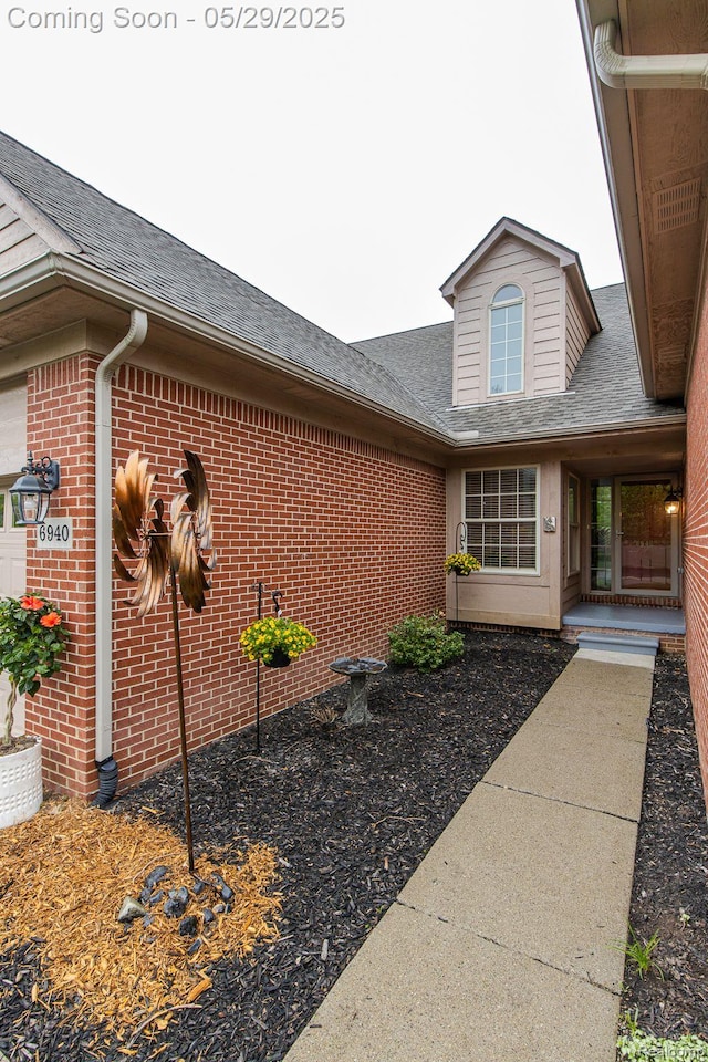 6940 Stonewood, Clarkston, MI 48346 - view of property exterior with a shingled roof and brick siding