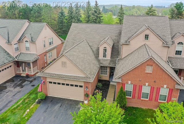 6940 Stonewood, Clarkston, MI 48346 - view of front of property with asphalt driveway, brick siding, a garage, and roof with shingles