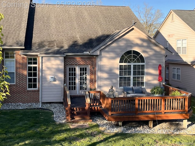 6940 Stonewood, Clarkston, MI 48346 - back of property featuring a wooden deck, roof with shingles, brick siding, a yard, and french doors