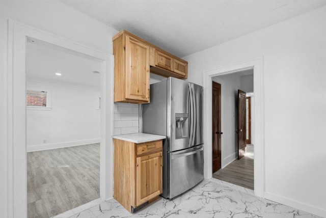 7305 Appoline St, Dearborn, MI 48126 - kitchen with stainless steel fridge with ice dispenser, light marble finish flooring, light countertops, baseboards, and decorative backsplash