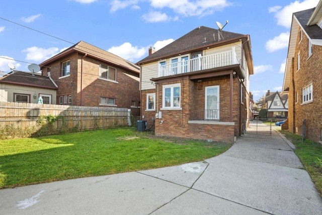 7305 Appoline St, Dearborn, MI 48126 - back of property with brick siding, driveway, a balcony, and central AC unit