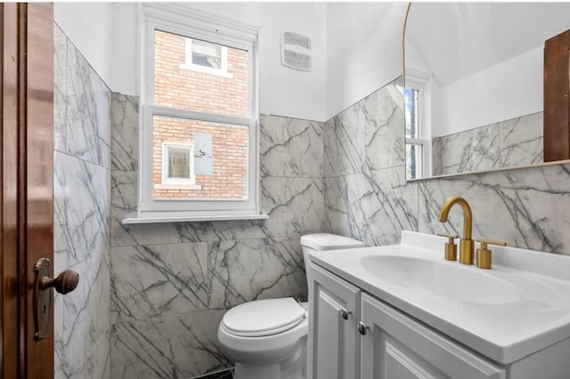 7305 Appoline St, Dearborn, MI 48126 - bathroom with tile walls, vanity, plenty of natural light, and toilet