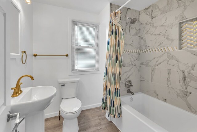 15053 Dumay St, Southgate, MI 48195 - full bathroom featuring toilet, baseboards, shower / bath combo with shower curtain, a sink, and wood finished floors