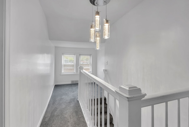 15053 Dumay St, Southgate, MI 48195 - hall featuring an upstairs landing, carpet, baseboards, and a chandelier