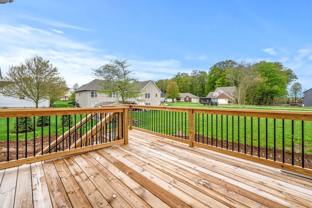 deck with a residential view and a lawn