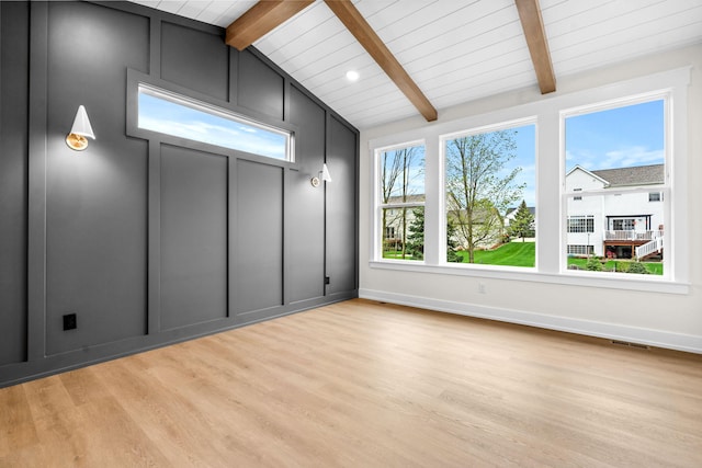 unfurnished room with light wood-style floors, baseboards, and wooden ceiling