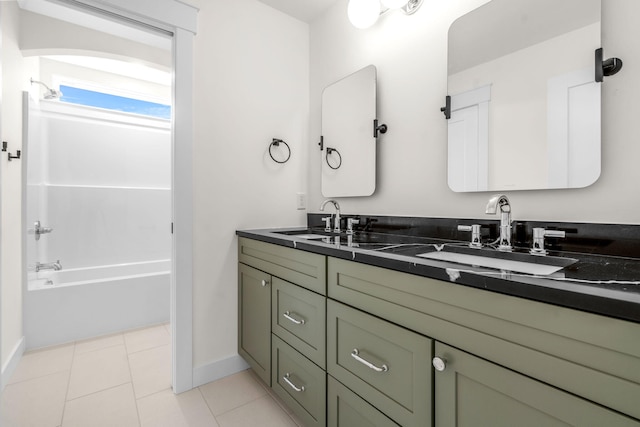 bathroom featuring double vanity, baseboards, washtub / shower combination, and tile patterned floors
