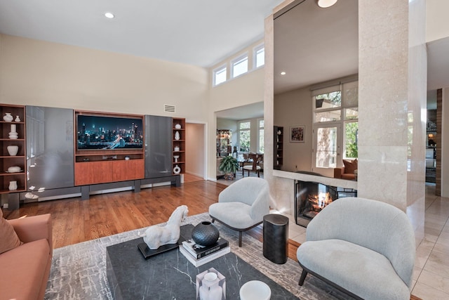 5280 Brookdale Rd, Bloomfield Hills, MI 48304 - living room with a high ceiling, wood finished floors, and a fireplace