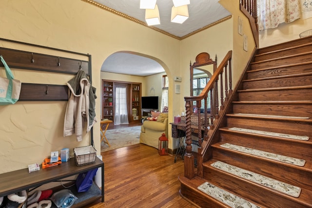 939 S Highland St, Dearborn, MI 48124 - entrance foyer featuring arched walkways, wood finished floors, stairs, healthy amount of natural light, and ornamental molding