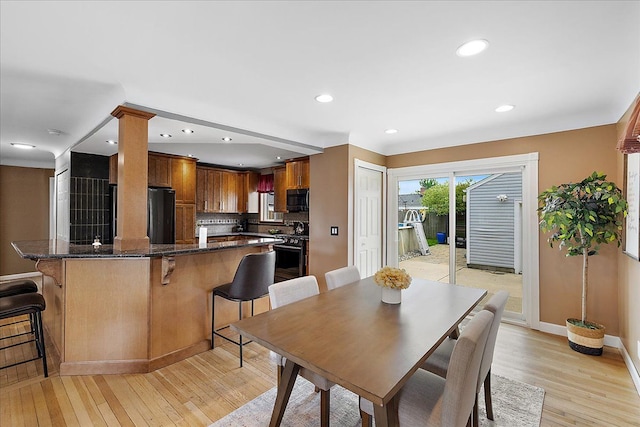 23142 Port St, Saint Clair Shores, MI 48082 - dining space featuring light wood finished floors, baseboards, ornate columns, and recessed lighting