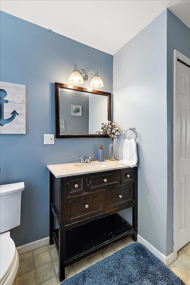 23142 Port St, Saint Clair Shores, MI 48082 - bathroom featuring baseboards, toilet, and vanity