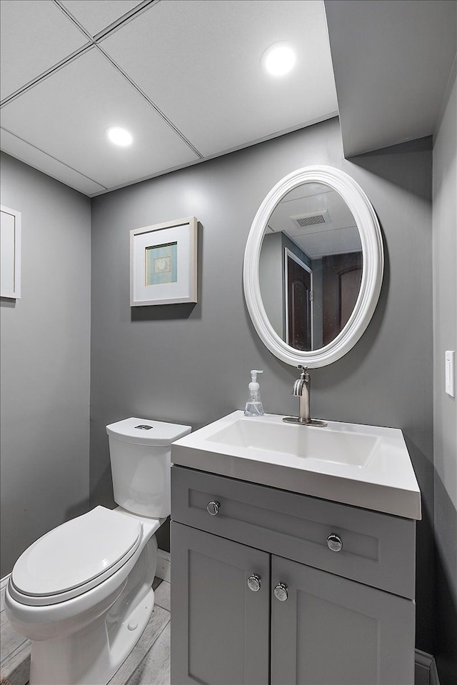 23142 Port St, Saint Clair Shores, MI 48082 - bathroom with toilet, baseboards, vanity, wood finished floors, and recessed lighting